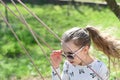 Freedom, carefree lifestyle and fun. Fashion girl in sunglasses enjoy swinging on sunny day. Little child on swing in summer yard. Royalty Free Stock Photo