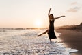Freedom Chinese woman feeling free dancing at beach sunset. Royalty Free Stock Photo