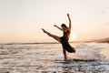 Freedom Chinese woman feeling free dancing at beach sunset. Royalty Free Stock Photo