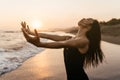 Freedom Chinese woman feeling free dancing at beach sunset. Royalty Free Stock Photo