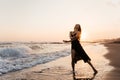 Freedom Chinese woman feeling free dancing at beach sunset. Royalty Free Stock Photo