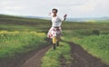 Freedom concept. Cheerful girl running on a countryside road Royalty Free Stock Photo