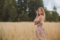 Freedom concept, elegant woman in long beige romantic dress at the field