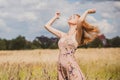 Freedom concept, elegant woman in long beige romantic dress at the field