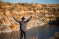 Freedom concept. Free man in sweater and black hat with open arms on sunset admire nature view of autumn lake. success Royalty Free Stock Photo