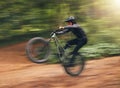 Freedom, energy and bike with adrenaline cyclist training in nature, practice extreme jumping trick on dirt road