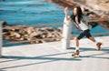 Freedom, energy and roller skating with black man training and exercise along a beach outdoors. Active African American