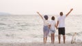 Freedom family on the beach. Mother, daughter and father against sea and sky background with dog. Happy holiday travel concept Royalty Free Stock Photo