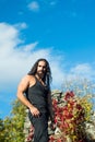 Freedom, feel good, travel and adventure concept. Stylish handsome macho man standing against sky and colorful ivy Royalty Free Stock Photo