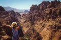 Freedom female wanderlust standing with raised hands enjoying majestic mountain landscape. Hipster young girl explore world. Summe