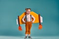 Freedom, girl playing to be airplane pilot, funny little girl carries wings made of cardboard as an airplane Royalty Free Stock Photo