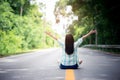 Freedom girl sitting in the middle of the mountain road with happy and relax Royalty Free Stock Photo