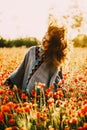 Happy beautiful woman relaxing in poppy flower field. Royalty Free Stock Photo