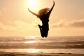 Freedom, jump and sunset with woman at beach for travel, celebration and winner. Success, summer and silhouette with Royalty Free Stock Photo