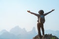 Freedom man hiker outstretched arms stand at cliff edge on mountain top.Concept of adventure travel Royalty Free Stock Photo