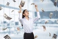 Freedom, money, wealth and busines success concept with happy woman on background under dollar banknotes rain