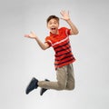 Happy smiling young boy jumping in air Royalty Free Stock Photo