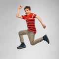 Happy smiling young boy jumping or running in air Royalty Free Stock Photo