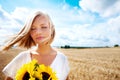 Freedom, nature and calm woman with a sunflower on a wheat field for travel or vacation. Peace, face and female person Royalty Free Stock Photo