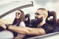 Freedom of the open road.Young Couple Driving Along Country Road In Open Top Car. Royalty Free Stock Photo