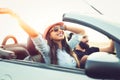 Freedom of the open road.Young Couple Driving Along Country Road In Open Top Car. Royalty Free Stock Photo