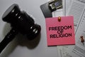 Freedom of Religion text on sticky notes and gavel  on office desk. Law concept Royalty Free Stock Photo