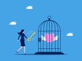 Freedom in savings and investments. Businesswoman uses a key to open a piggy bank in a cage. business concept