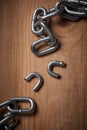 Freedom, security and broken metal chain for mental health, conflict and power on wood background. Steel, link and Royalty Free Stock Photo