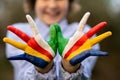 Freedom Seychelles concept. Cute child forming flying bird gesture with hands painted in Seychelles flag colors Royalty Free Stock Photo