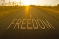 Freedom sign on asphalt road