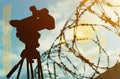 Double exposure - camera, barbed wire and flag Kazakhstan