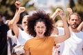 Freedom, support and protest with black woman and fist with crowd in city street for global justice and human rights Royalty Free Stock Photo