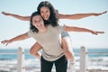 Freedom, travel and portrait of piggyback couple at beach, happy and playful against blue sky background. Face, airplane Royalty Free Stock Photo