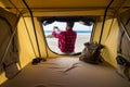 Freedom traveler man outside the tent in alternative vacation lifestyle in free camping at the beach taking picture of the natura Royalty Free Stock Photo