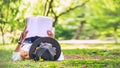 .Freedom traveler woman Lying down reading in the The park and enjoying a beautiful nature. space for text Royalty Free Stock Photo