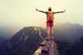 Female hiker open arms to the great wall on the top of mountain Royalty Free Stock Photo
