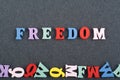 FREEDOM word on black board background composed from colorful abc alphabet block wooden letters, copy space for ad text. Learning Royalty Free Stock Photo