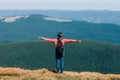 Freedom young girl with hands up in mountains Royalty Free Stock Photo