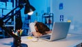 Freelance Asia exhausted lady hard work sleeping at new normal home office. Working from house overload at night, Remotely, self Royalty Free Stock Photo