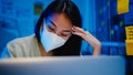 Freelance Asia women wear face mask using laptop hard work at new normal office.