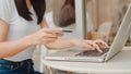 Freelance Asian women online shopping at coffee shop. Young Asia Girl using laptop, credit card buy and purchase e-commerce on Royalty Free Stock Photo