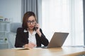 Freelance business woman calling on mobile smartphone while working with laptop, businesswoman mobile phone to calling with
