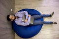 Freelance businessman. Young handsome man sleep with laptop sitting on the blue beanbag Royalty Free Stock Photo