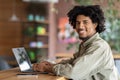 Freelance Career. Happy Young Black Man Working Remotely With Laptop At Cafe Royalty Free Stock Photo