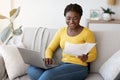 Freelance Career. Positive Black Lady Working With Papers And Laptop At Home Royalty Free Stock Photo