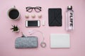 Freelance Concept with laptop paper notebook phone, sheet, pencils, candy, coffee, headphones, plant pencils on pink background. Royalty Free Stock Photo