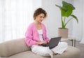Freelance Concept. Young Woman Using Laptop While Sitting On Couch At Home Royalty Free Stock Photo