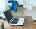 Freelance Desk with laptop in mess at home apartment. Quarantine, self-isolation, sociophobia