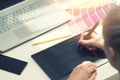 Freelance graphic designer using digital drawing tablet