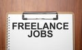 freelance jobs text on white paper on the wood table